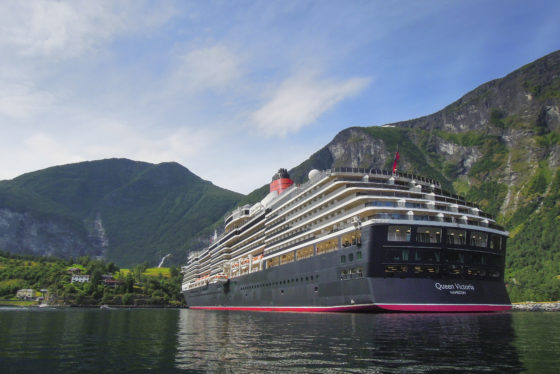 MS Queen Victoria moored in the town of Flam in the Aurerlandsfjord in Norway.
